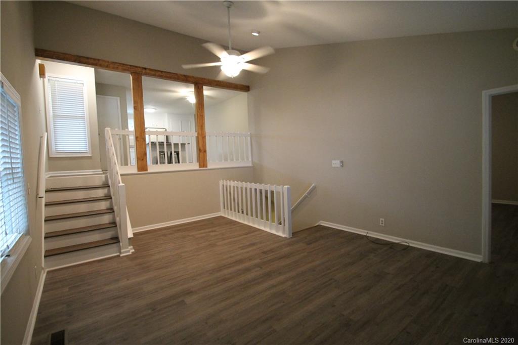28006 Marina Drive, Unit 6 Tega Cay, SC 29708 - Photo 9 of 32 an empty room with wooden floor and windows