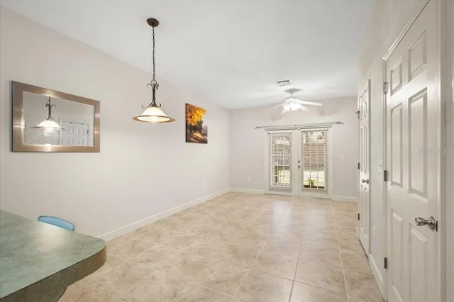 a view of an empty room with window and cabinet