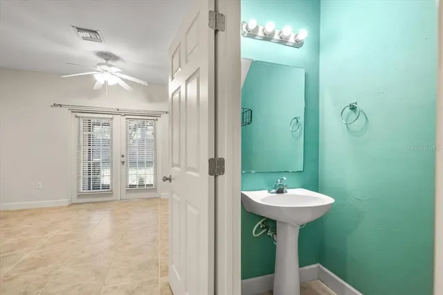 a bathroom with a sink a mirror and a shower