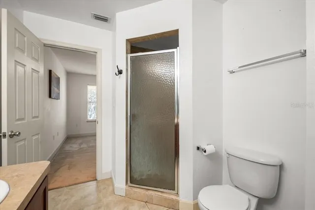 a bathroom with a toilet and a shower