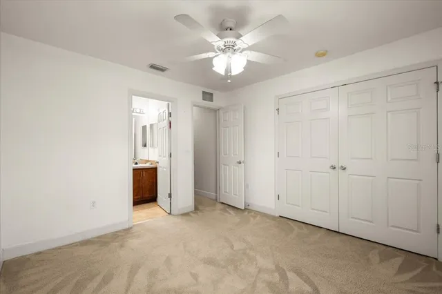 a view of an empty room with a ceiling fan