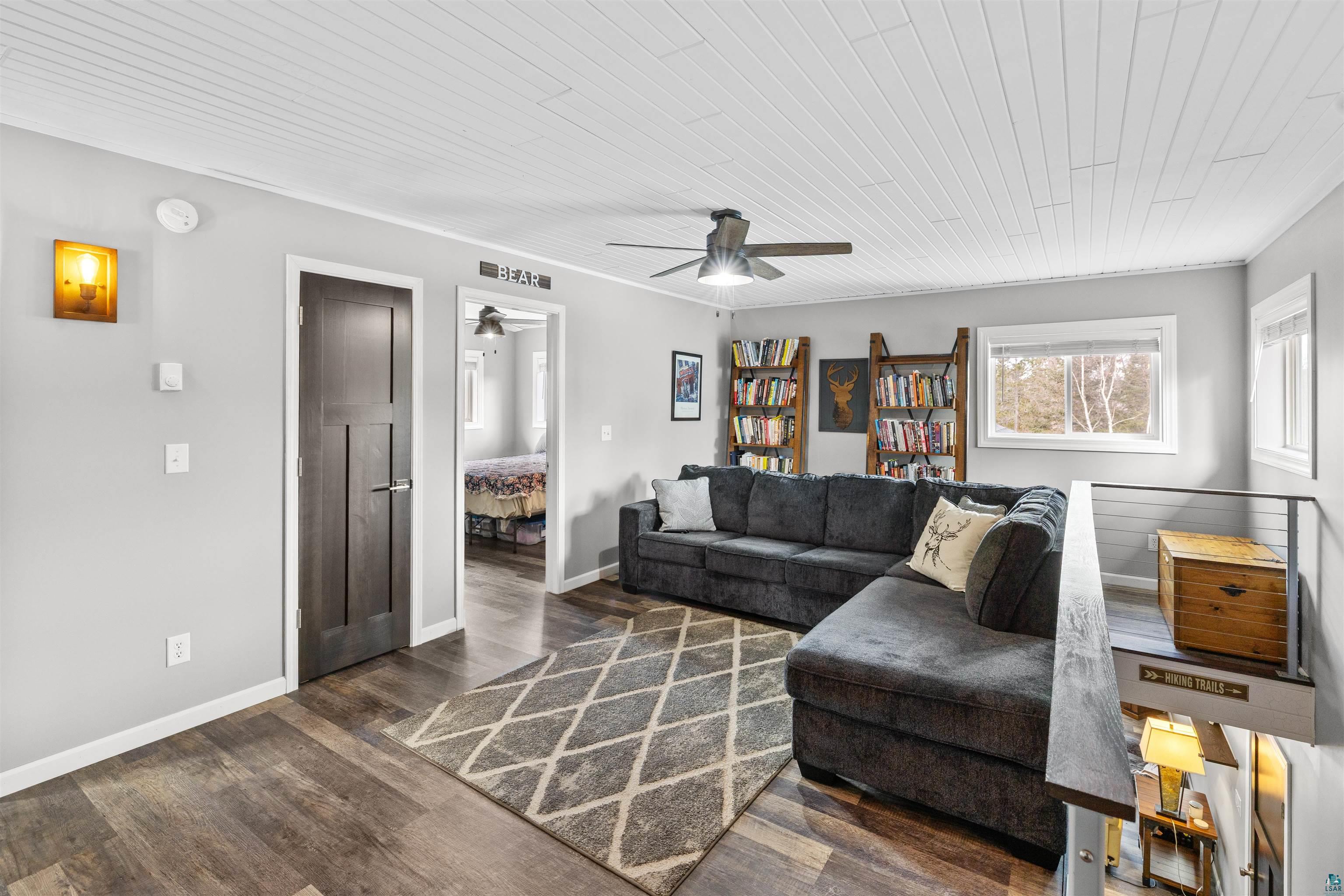 13462 Villa Road Ely, MN 55731 - Photo 10 of 68 Living room with Lifeproof flooring, a ceiling fan, and wooden ceiling