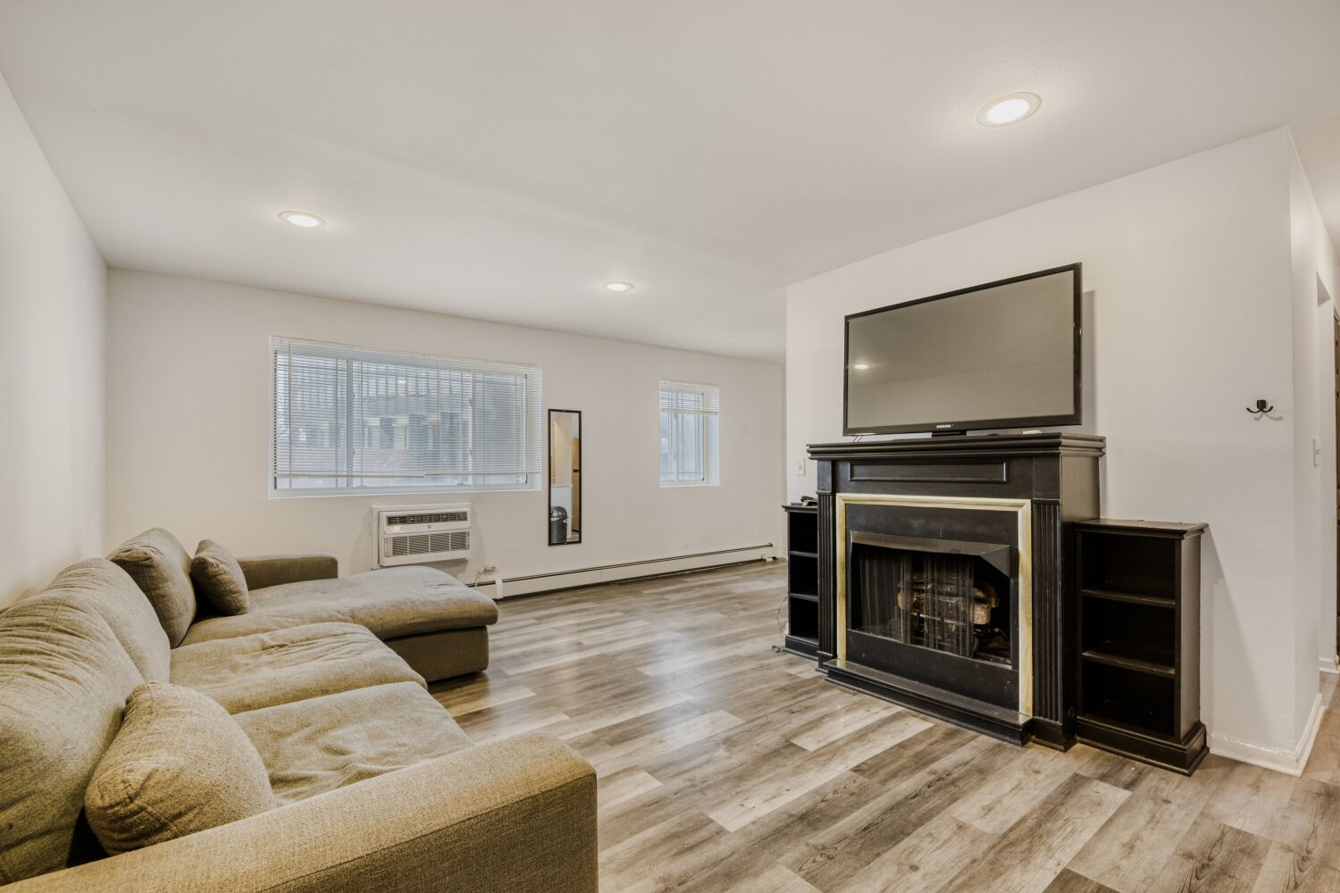5400 North Sheridan Road, Unit 202 Chicago, IL 60640 - Photo 2 of 11 a living room with furniture and a fireplace