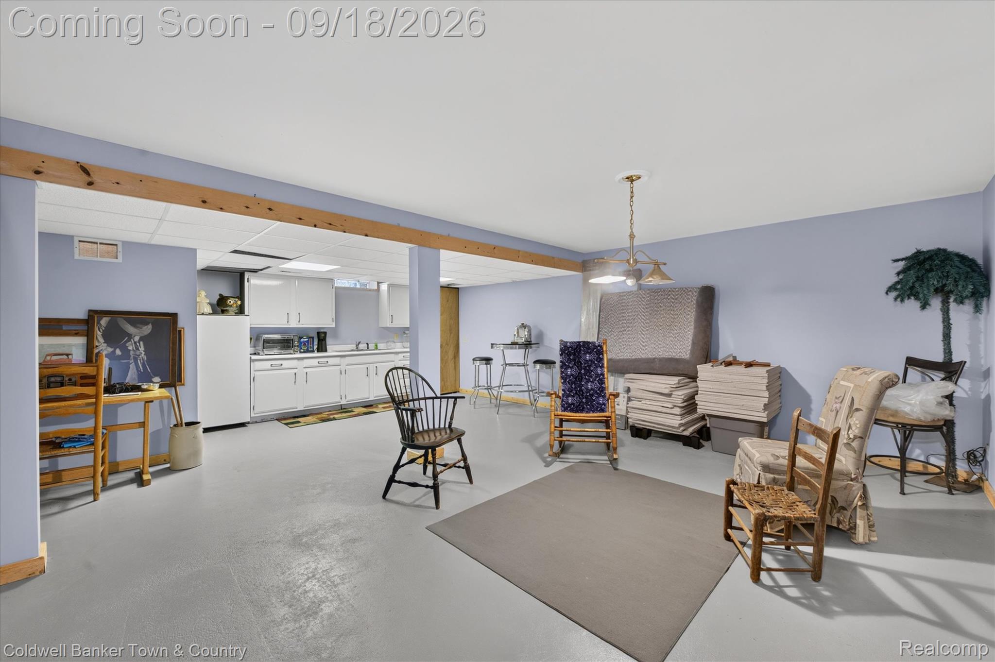 4442 McGunn Road Howell, MI 48843 - Photo 32 of 63 Lower level with wood-beam accents, a drop ceiling, and a light fixture