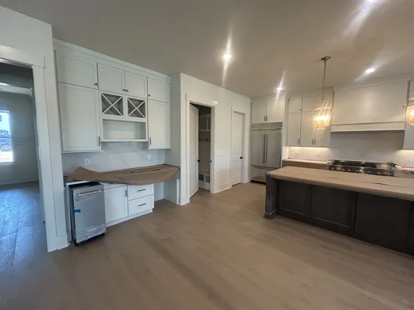 a large kitchen with kitchen island a sink stainless steel appliances and cabinets