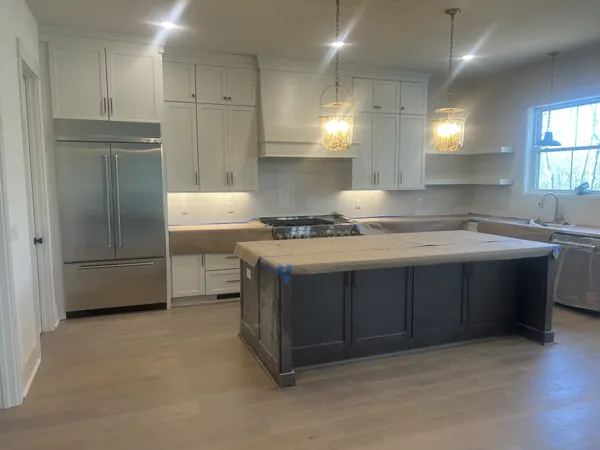 a kitchen with kitchen island a sink stainless steel appliances and cabinets