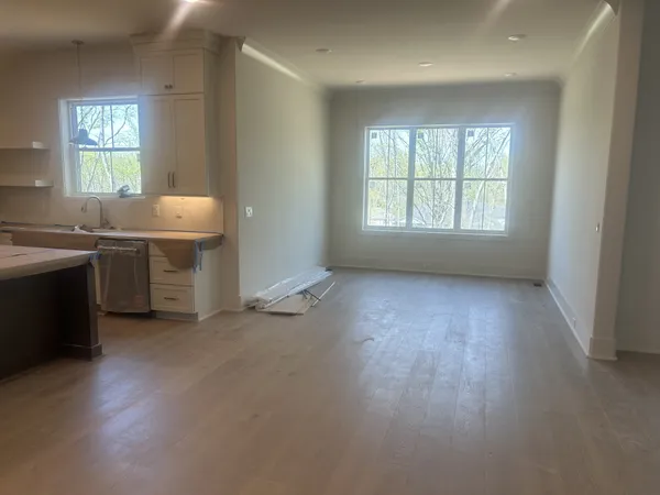 a view of a kitchen with a sink dishwasher and a fireplace