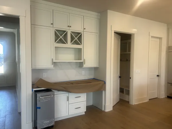a kitchen with white cabinets and stainless steel appliances