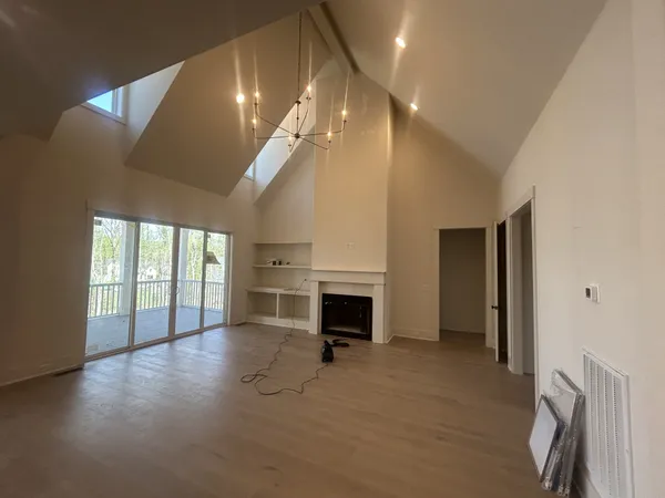 a view of a livingroom with a fireplace and window
