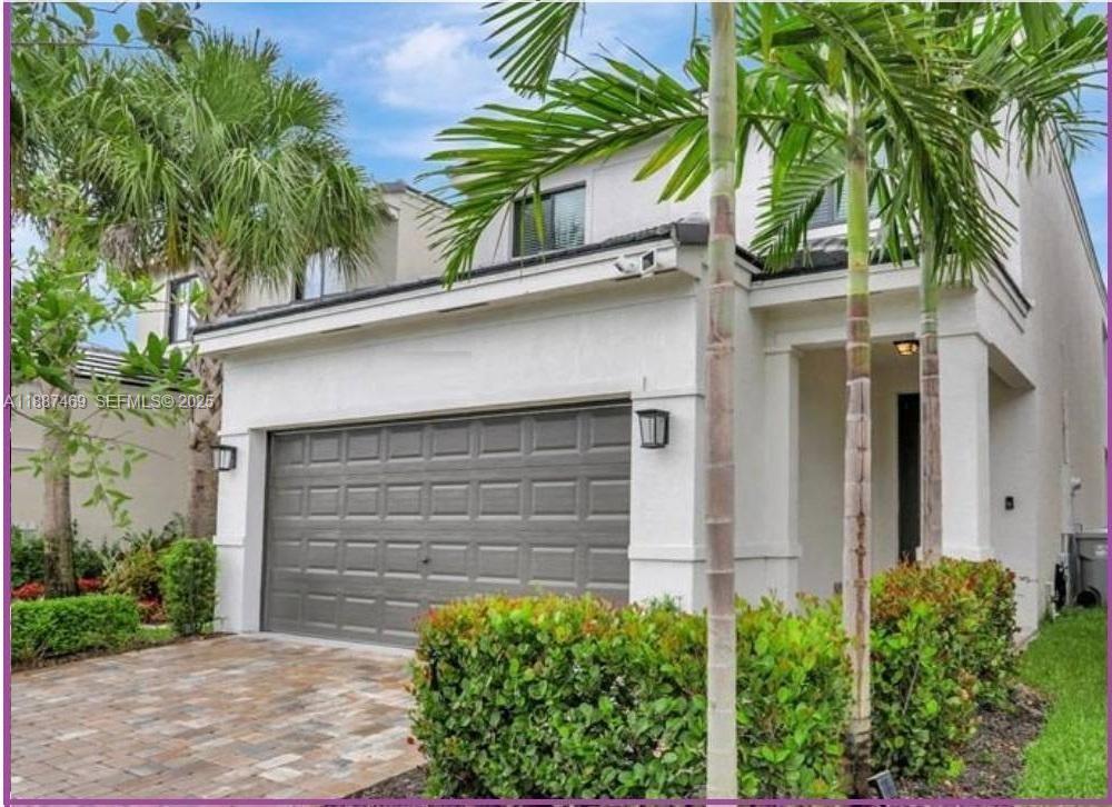 a view of front door and small plants