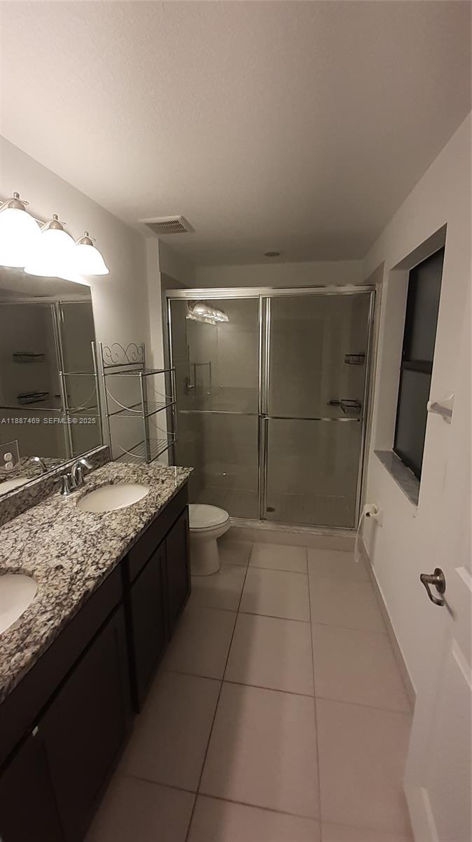 3575 Northwest 1st Street Pompano Beach, FL 33069 - Photo 9 of 18 a bathroom with a granite countertop sink a large mirror and a shower