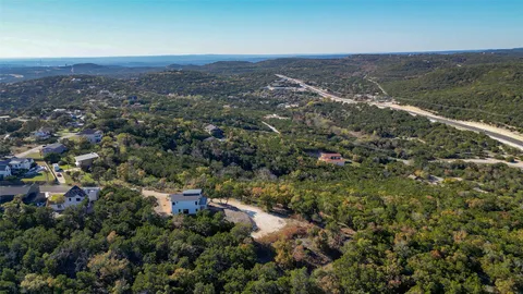 an aerial view of house with yard and mountain view in back
