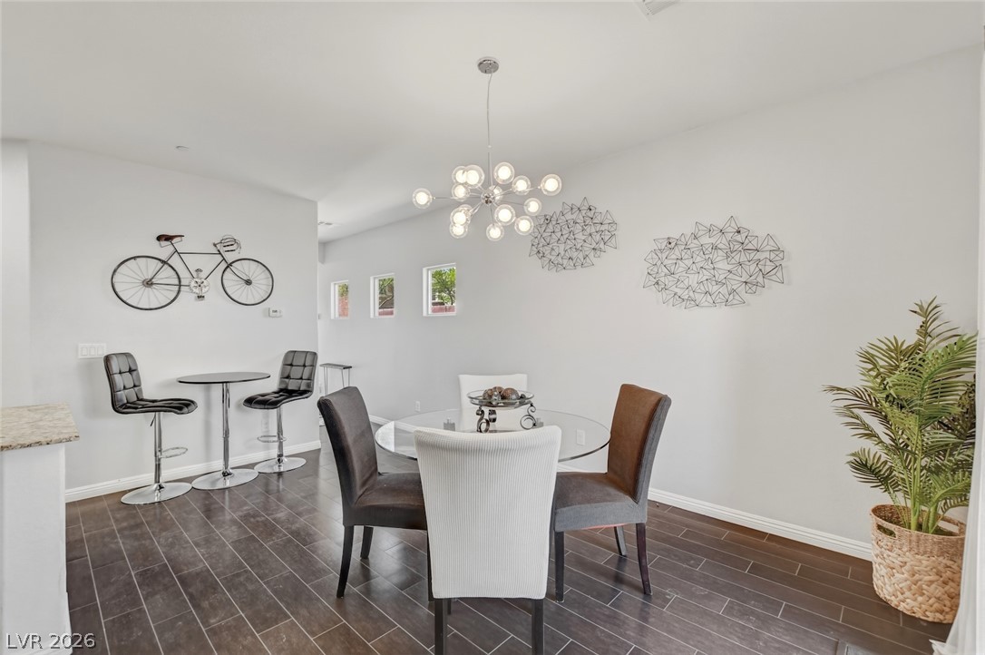 48 Jasmine Point Street Henderson, NV 89074 - Photo 14 of 62 Hardwood-style flooring and abundant natural light highlight this dining area.