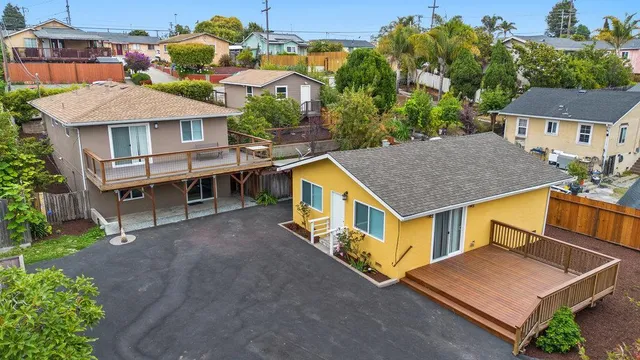 an aerial view of a house with a yard table and chairs