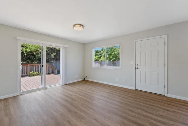 a view of kitchen with a sink refrigerator and wooden floor