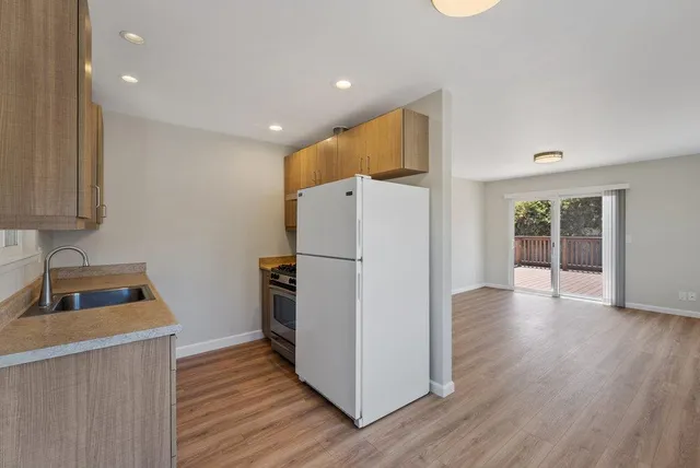a kitchen with a stove and a refrigerator