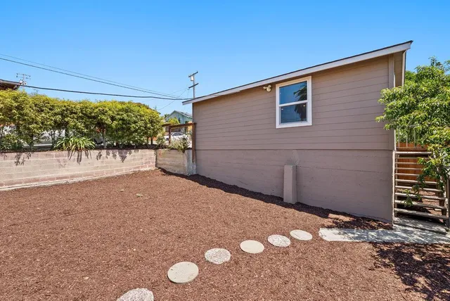 an aerial view of a house with a yard and potted plants