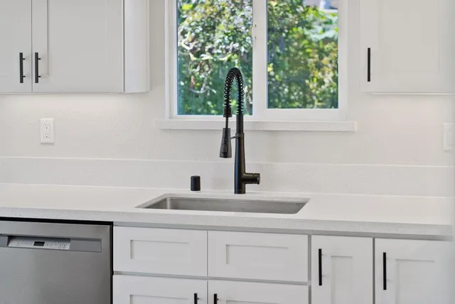 a kitchen with a sink and a window