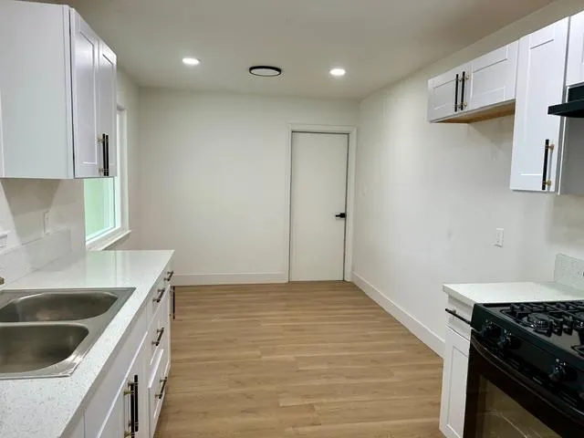 a kitchen that has a sink and a stove