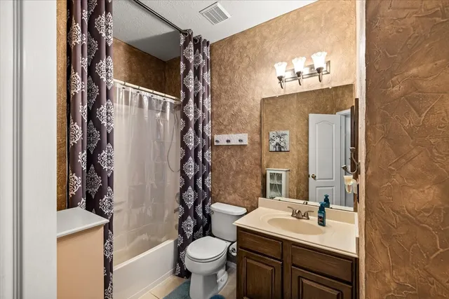 a view of hallway with furniture and windows