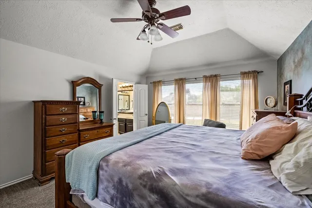 a bedroom with a bed window and couch