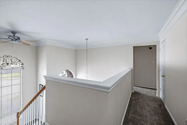 a bedroom with a bed and ceiling fan