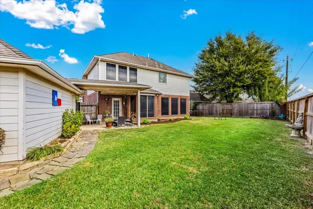 an aerial view of a house with a garden and lake view