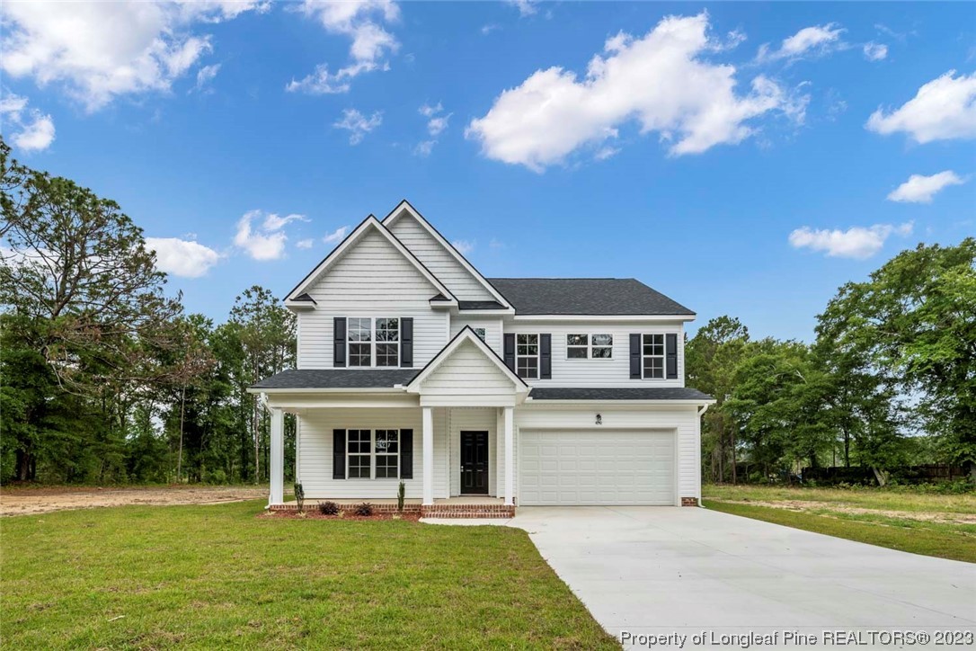 4750 Blue Sand Hill Road Fayetteville, NC 28312 - Photo 1 of 42 a front view of a house with a garden and yard
