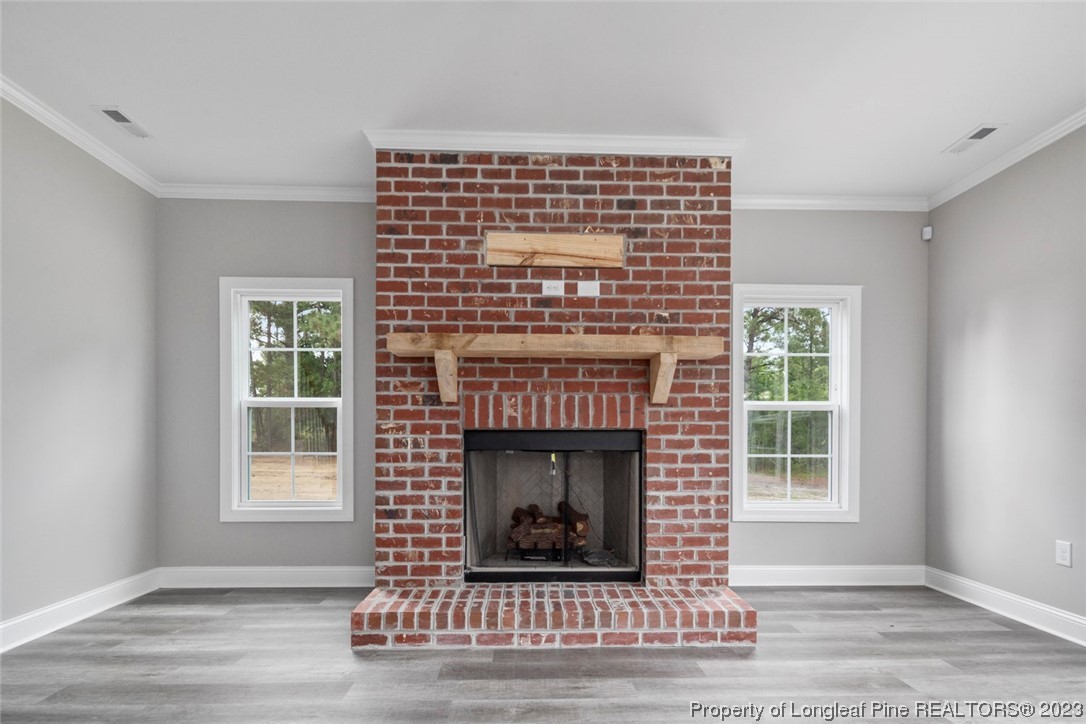 4750 Blue Sand Hill Road Fayetteville, NC 28312 - Photo 13 of 42 a living room with a fireplace in it and a window