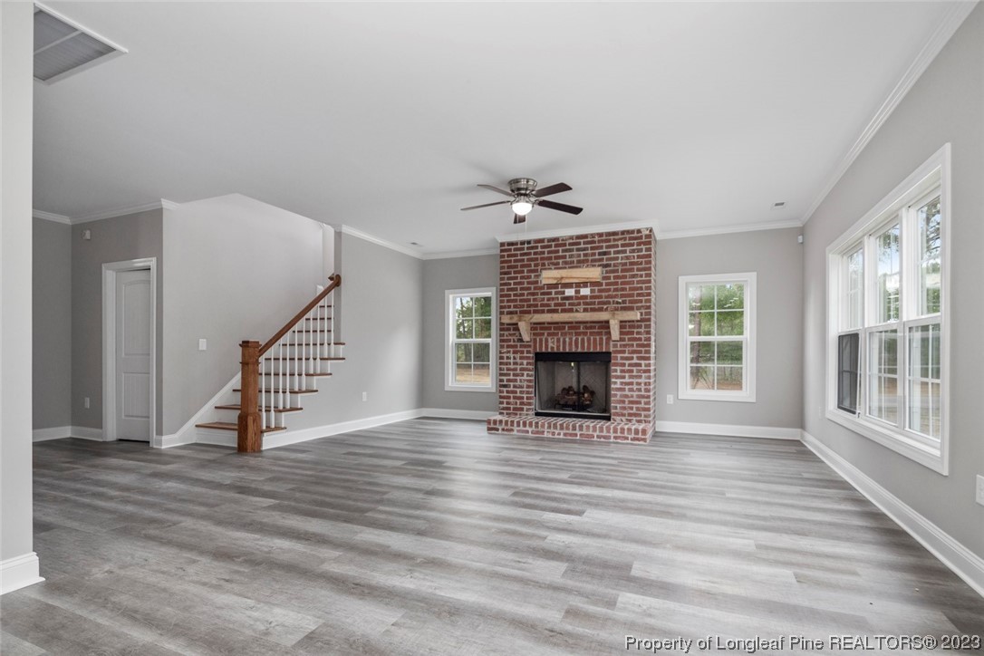4750 Blue Sand Hill Road Fayetteville, NC 28312 - Photo 14 of 42 a view of an empty room with wooden floor fireplace and a window