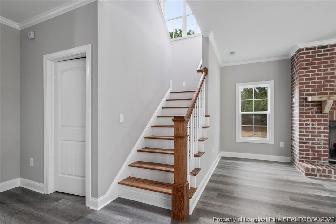 4750 Blue Sand Hill Road Fayetteville, NC 28312 - Photo 22 of 42 a view of a hallway with wooden floor and entryway