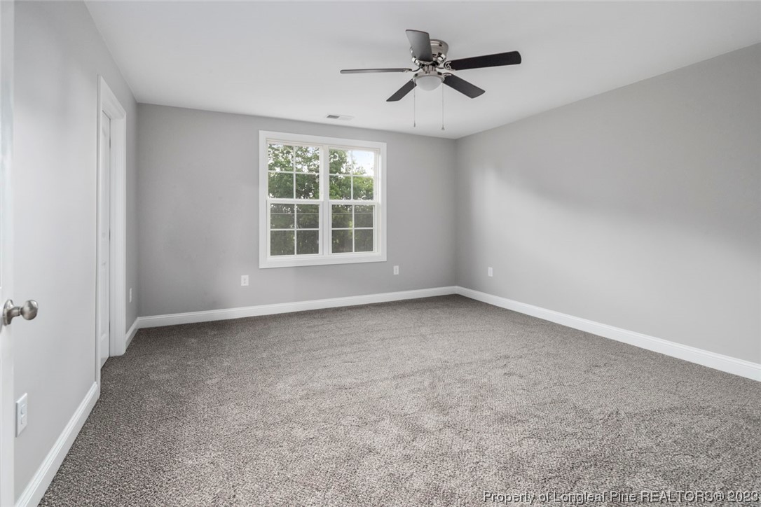 4750 Blue Sand Hill Road Fayetteville, NC 28312 - Photo 24 of 42 an empty room with a empty space and a ceiling fan