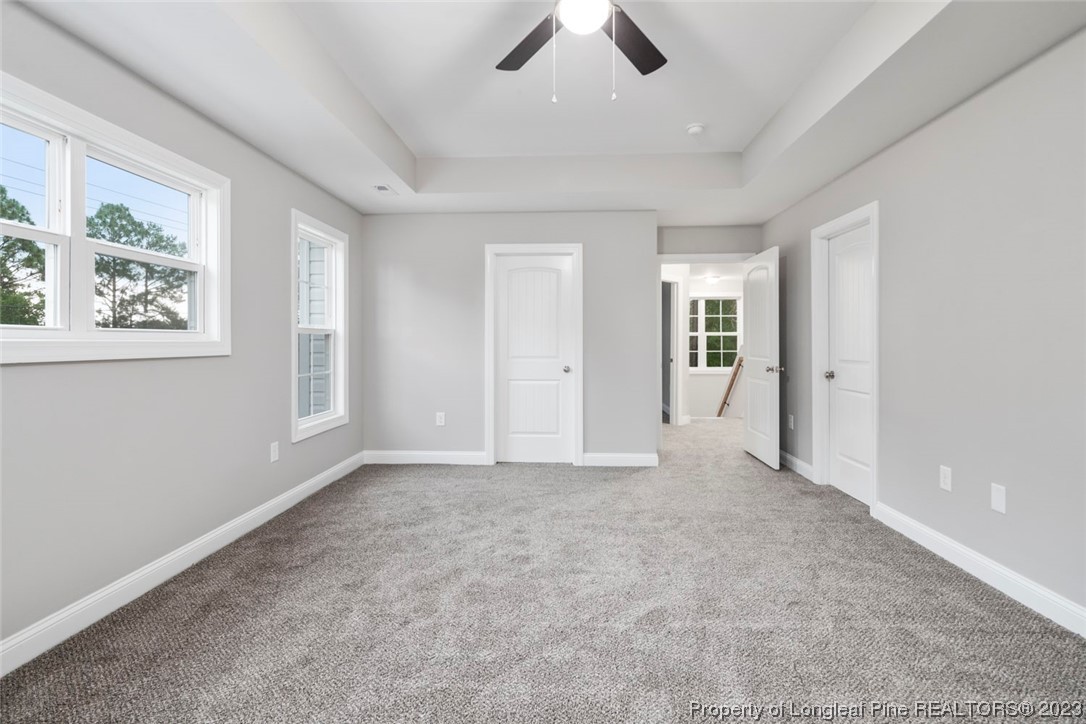 4750 Blue Sand Hill Road Fayetteville, NC 28312 - Photo 27 of 42 an empty room with chandelier fan and windows