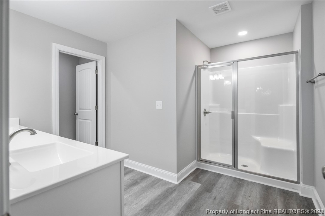 4750 Blue Sand Hill Road Fayetteville, NC 28312 - Photo 28 of 42 a view of a bathroom with a sink and a mirror