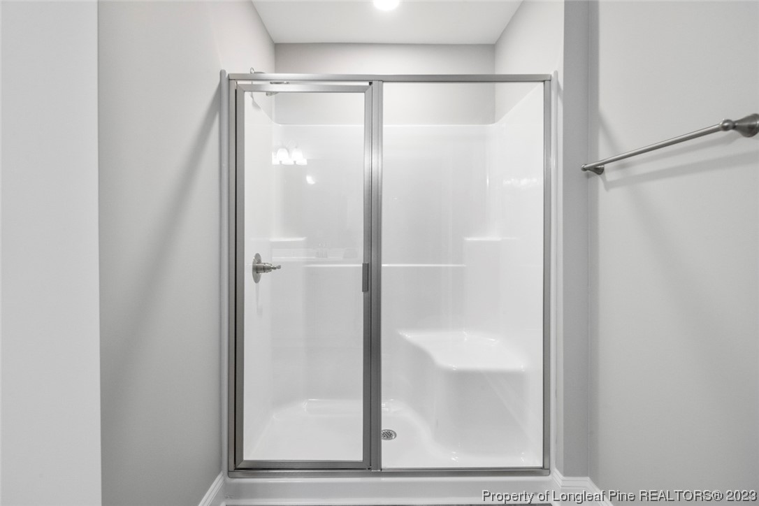 4750 Blue Sand Hill Road Fayetteville, NC 28312 - Photo 29 of 42 a bathroom with a glass shower door