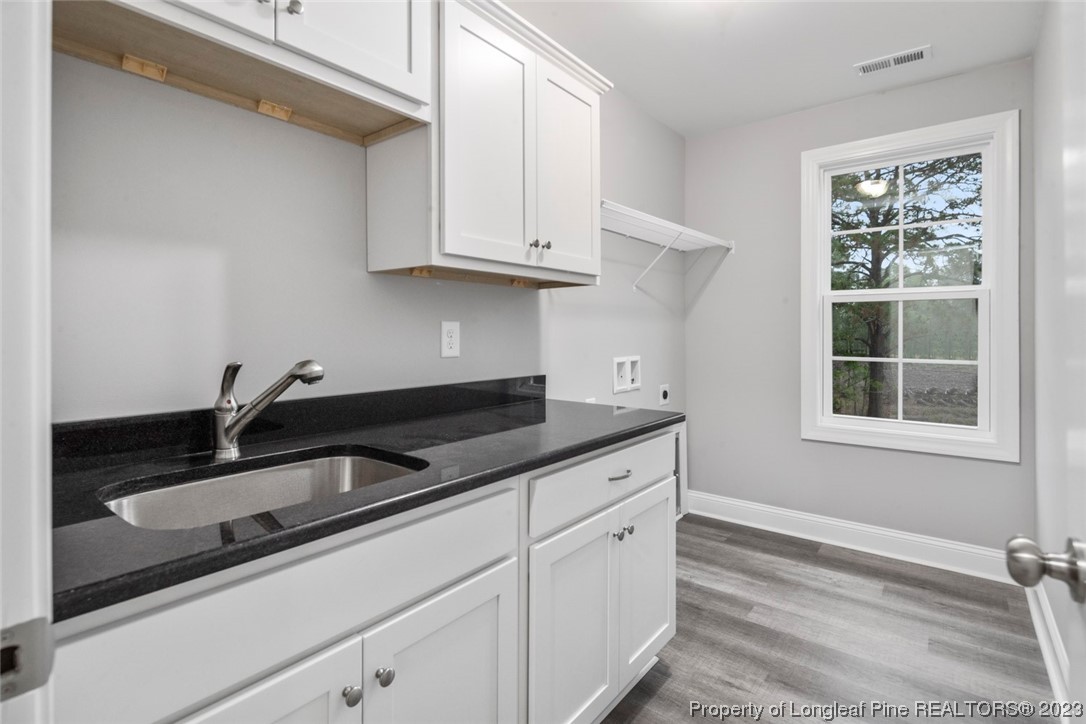 4750 Blue Sand Hill Road Fayetteville, NC 28312 - Photo 31 of 42 a kitchen with granite countertop white cabinets and sink
