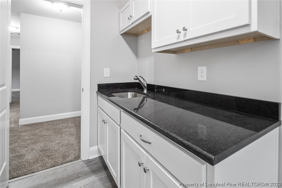 4750 Blue Sand Hill Road Fayetteville, NC 28312 - Photo 33 of 42 a kitchen with a sink and cabinets