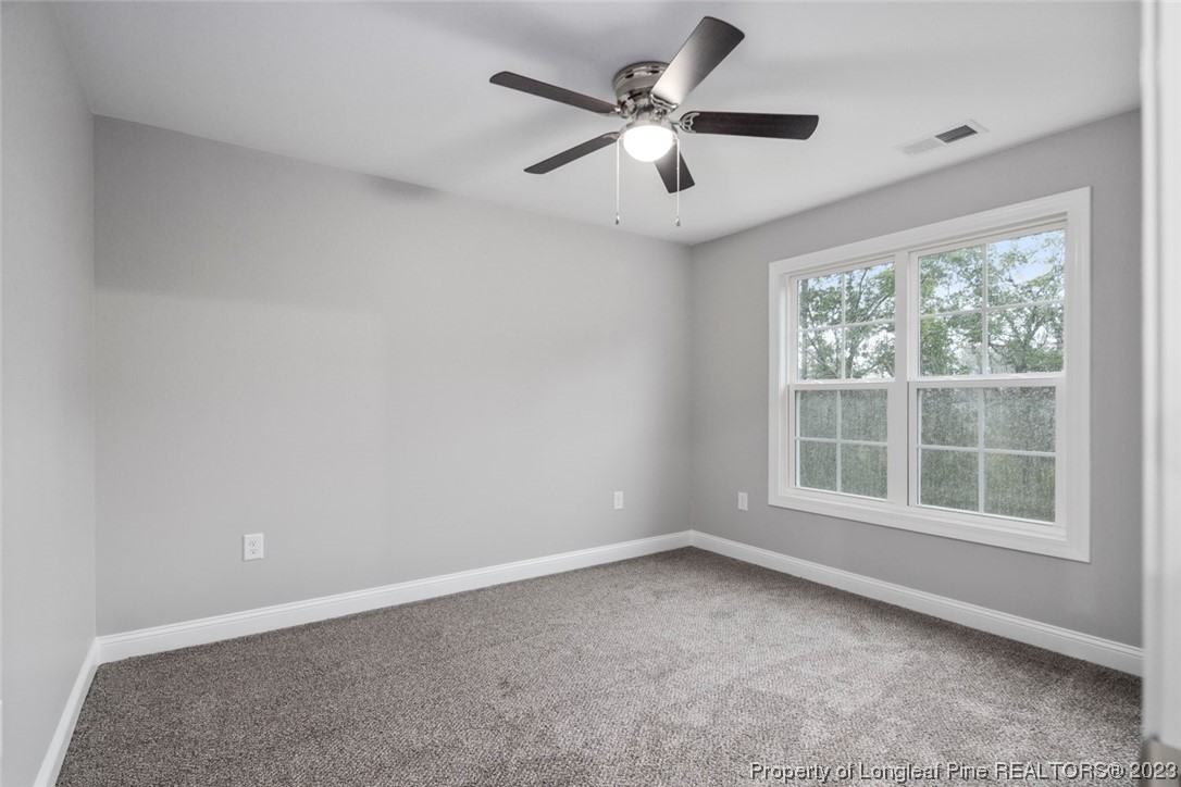 4750 Blue Sand Hill Road Fayetteville, NC 28312 - Photo 34 of 42 an empty room with a window and a fan