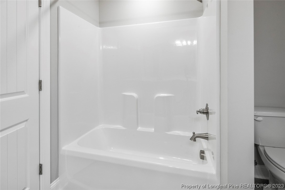 4750 Blue Sand Hill Road Fayetteville, NC 28312 - Photo 36 of 42 a white bath tub sitting next to a white sink