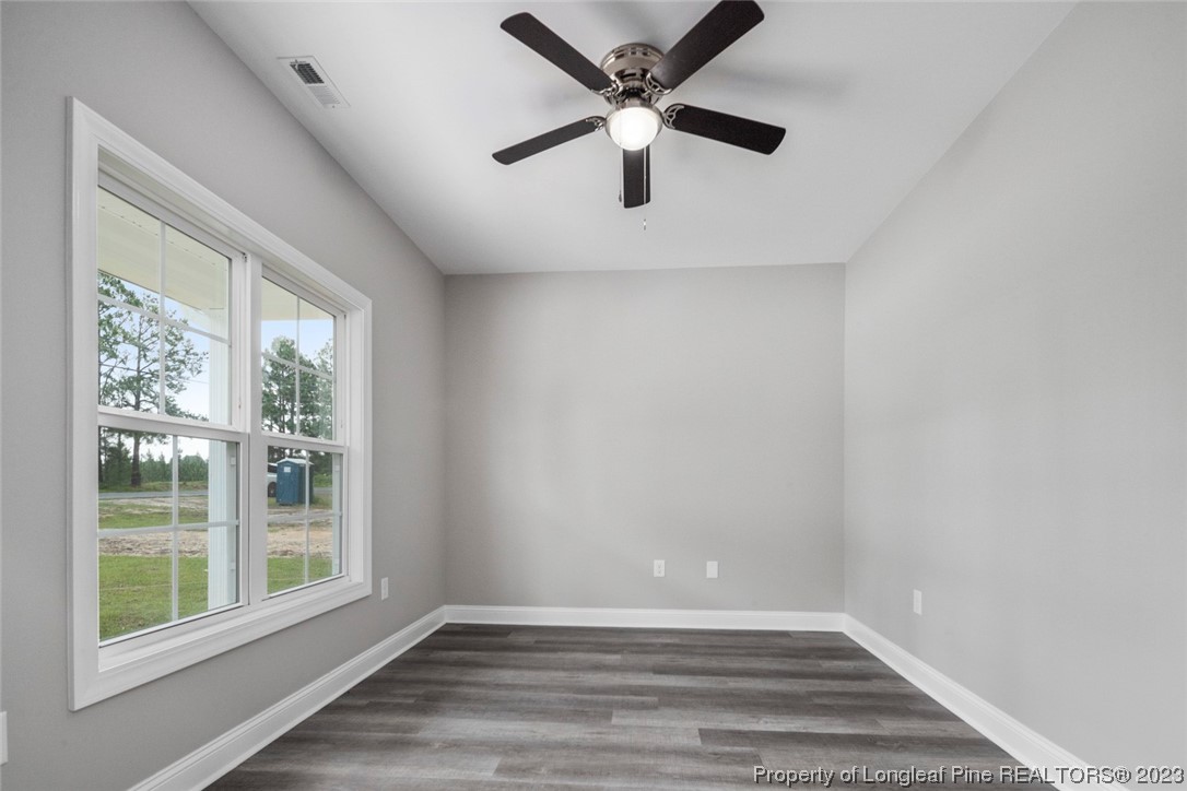 4750 Blue Sand Hill Road Fayetteville, NC 28312 - Photo 9 of 42 a view of an empty room with wooden floor and a window