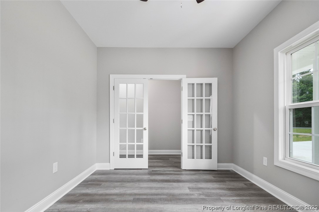 4750 Blue Sand Hill Road Fayetteville, NC 28312 - Photo 10 of 42 an empty room with wooden floor and windows