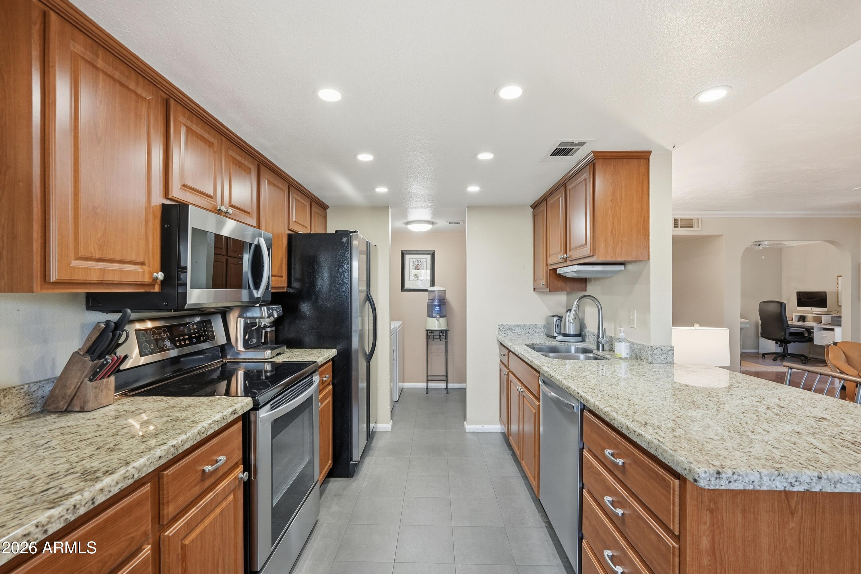 633 East Calavar Road Phoenix, AZ 85022 - Photo 6 of 24 Kitchen island ope to living