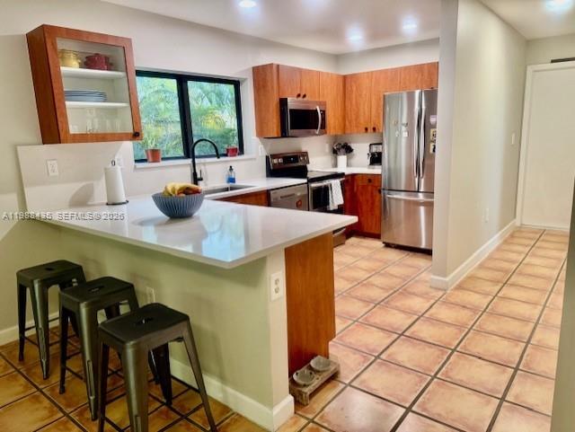 18163 Southwest 149th Place Miami, FL 33187 - Photo 43 of 49 a kitchen with stainless steel appliances a sink a stove a refrigerator a counter top space and cabinets