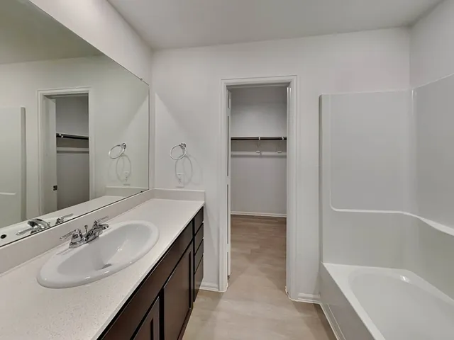 a bathroom with a sink vanity and mirror