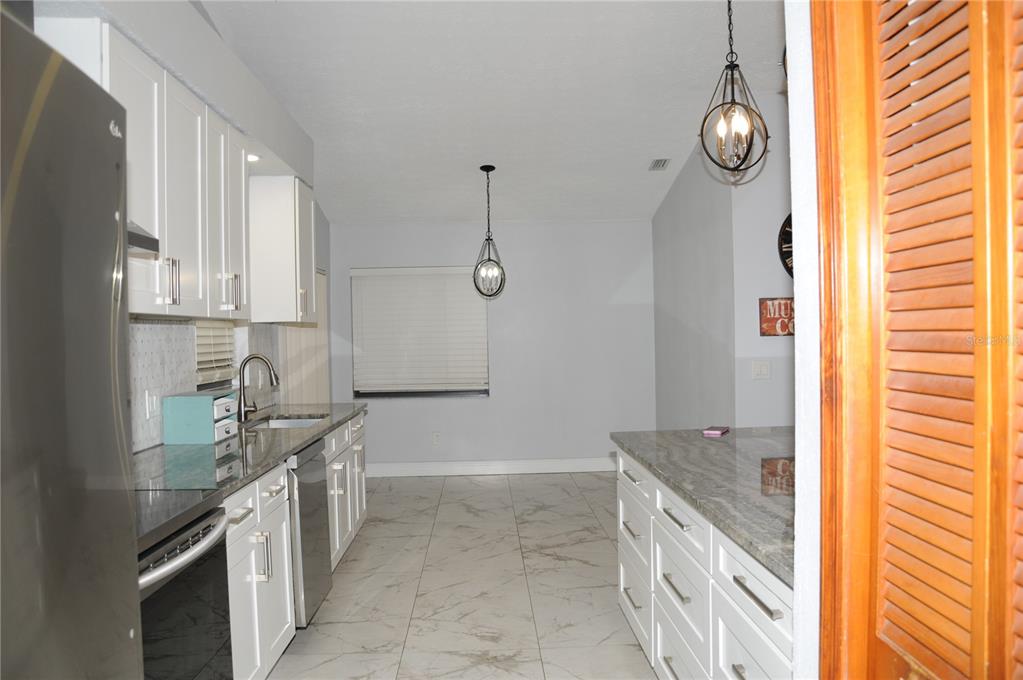 2106 Whitlock Place Dover, FL 33527 - Photo 12 of 83 a kitchen with granite countertop a sink and a stove