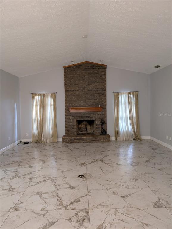 2106 Whitlock Place Dover, FL 33527 - Photo 23 of 83 a view of an empty room with window and fireplace