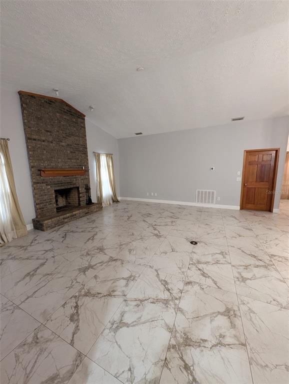 2106 Whitlock Place Dover, FL 33527 - Photo 25 of 83 a view of empty room with fireplace