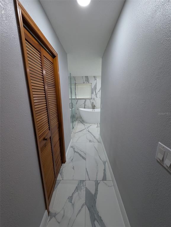 2106 Whitlock Place Dover, FL 33527 - Photo 29 of 83 a view of a hallway and a toilet
