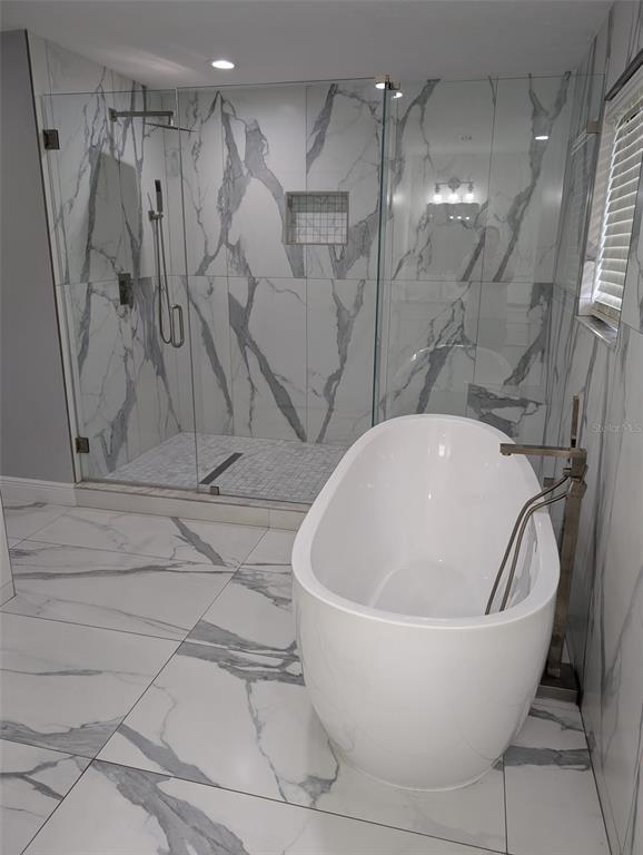 2106 Whitlock Place Dover, FL 33527 - Photo 32 of 83 a white bath tub sitting in a bathroom and shower