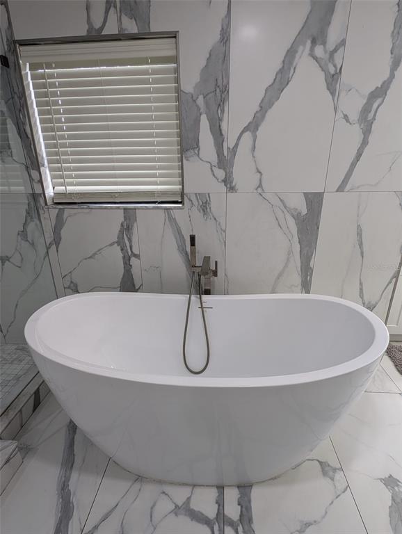 2106 Whitlock Place Dover, FL 33527 - Photo 35 of 83 a white bath tub sitting next to a white sink